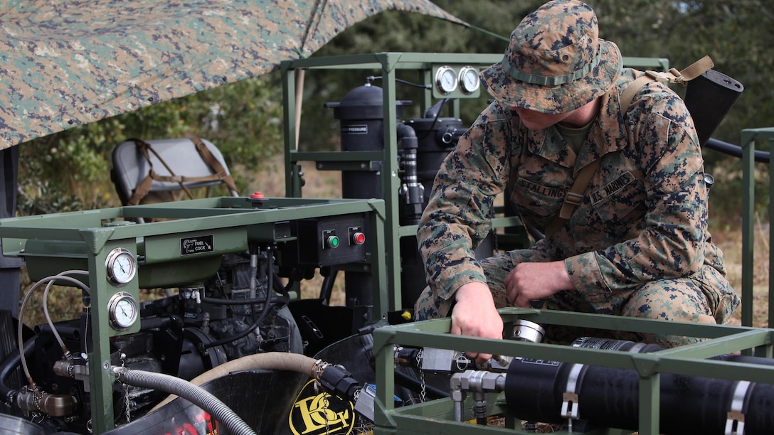 Lance Cpl. Quentin J. Stallings evaluates the settings on a water filter and pump at Marine Corps Auxiliary Landing Field Bogue, N.C., Dec. 9, 2015. Marines with Marine Wing Support Squadron 271’s Engineer Company participated in a cantonment and capabilities field exercise to practice and improve their knowledge of their jobs while in a deployed environment. The weeklong exercise featured events such as airfield damage repair, water purification, medium and heavy lifting missions, with the construction of an expedient road for a vertical take-off and landing aircraft pad. Stallings is a water support technician with MWSS-271.