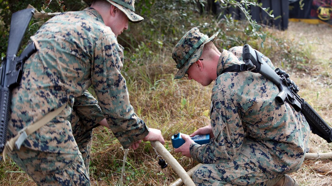 Lance Cpl. Quentin J. Stallings, left, and Lance Cpl. Kyle H. Clemens, right, configure the settings on a water pump and filter at Marine Corps Auxiliary Landing Field Bogue, N.C., Dec. 9, 2015. Marines with Marine Wing Support Squadron 271’s Engineer Company participated in a cantonment and capabilities field exercise to practice and improve their knowledge of their jobs while in a deployed environment. The week-long exercise featured events such as airfield damage repair, water purification, medium and heavy lifting missions, with the construction of an expedient road for a vertical take-off and landing aircraft pad. Stallings and Clemens are both water support technicians with MWSS-271.