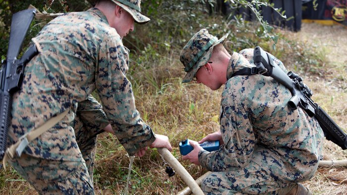 Lance Cpl. Quentin J. Stallings, left, and Lance Cpl. Kyle H. Clemens, right, configure the settings on a water pump and filter at Marine Corps Auxiliary Landing Field Bogue, N.C., Dec. 9, 2015. Marines with Marine Wing Support Squadron 271’s Engineer Company participated in a cantonment and capabilities field exercise to practice and improve their knowledge of their jobs while in a deployed environment. The week-long exercise featured events such as airfield damage repair, water purification, medium and heavy lifting missions, with the construction of an expedient road for a vertical take-off and landing aircraft pad. Stallings and Clemens are both water support technicians with MWSS-271.