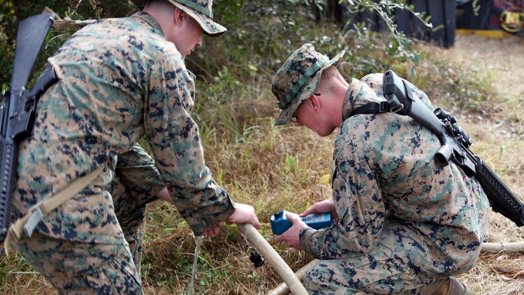 Lance Cpl. Quentin J. Stallings, left, and Lance Cpl. Kyle H. Clemens, right, configure the settings on a water pump and filter at Marine Corps Auxiliary Landing Field Bogue, N.C., Dec. 9, 2015. Marines with Marine Wing Support Squadron 271’s Engineer Company participated in a cantonment and capabilities field exercise to practice and improve their knowledge of their jobs while in a deployed environment. The week-long exercise featured events such as airfield damage repair, water purification, medium and heavy lifting missions, with the construction of an expedient road for a vertical take-off and landing aircraft pad. Stallings and Clemens are both water support technicians with MWSS-271.