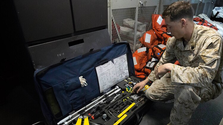 U.S. Marine Sgt. Peter A. Lawson, an explosive ordnance disposal technician with Combat Logistics Battalion 26, 26th Marine Expeditionary Unit, explains the different tools included in an EOD hook and line kit and their applications during an EOD demonstration aboard the amphibious assault ship USS Kearsarge in the Arabian Gulf Dec. 12, 2015. The 26th MEU is embarked on the Kearsarge Amphibious Ready Group and is deployed to maintain regional security in the U.S. 5th Fleet area of operations. 