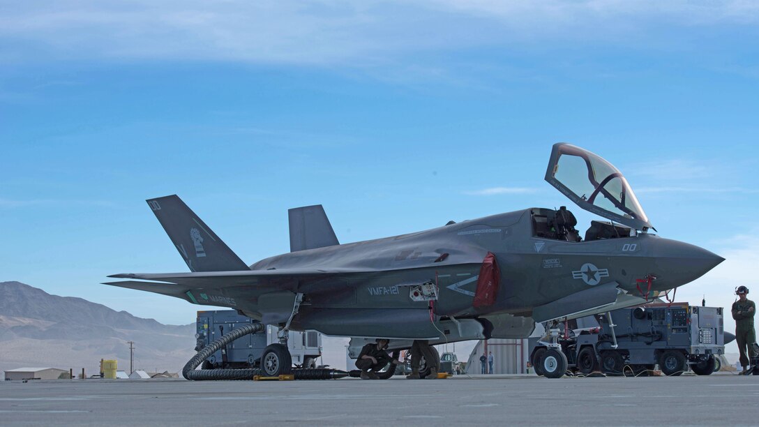 Marines hook up a hose for a power cart before a weapons functional test during Exercise Steel Knight at Marine Corps Air Ground Combat Center Twentynine Palms, California, Dec. 10, 2015. The Marines are with Marine Fighter Attack Squadron 121 and Marine Operational and Test Evaluation Squadron 22. The F-35B is a single seat, single engine stealth multi-role fighter bringing the Marine Corps into a whole new generation of aircraft. Exercise Steel Knight allowed for VMFA-121 and VMX-22 to train on integrating the F-35B and find its place in the Marine Air Ground Task Force, while giving the ground forces of 1st Marine Division the ability to become familiar with it.