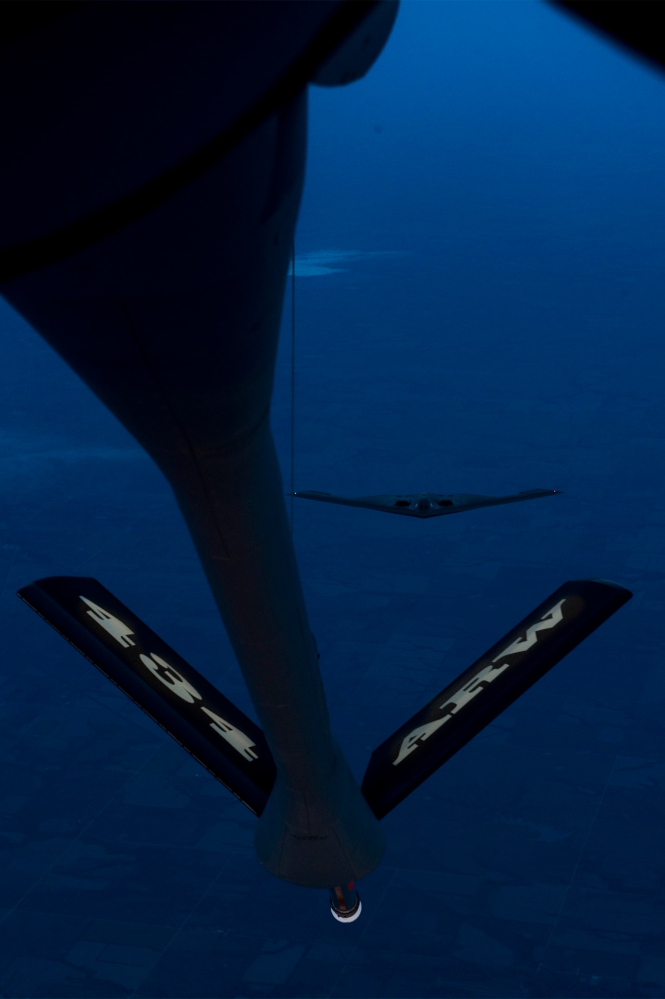 A B-2 Spirit from the 509th Bomb Wing, 13th Bomb Squadron Whiteman Air Force Base, Miss., prepares to be refueled by a KC-135R Stratotanker from the 434th Air Refueling Wing at Grissom Air Reserve Base, Ind. during a night-time aerial refueling mission over Southern Kansas, Oct. 21, 2015. During nighttime refueling, boom operators can use the natural light from the stars and the moon to help refuel the receiver aircraft. (U.S. Air Force photo/Tech. Sgt. Benjamin Mota)