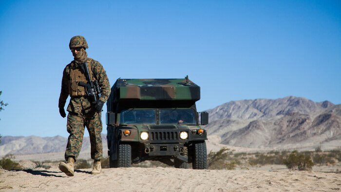 A Marine escorts an ambulatory HMMWV to a Shock Trauma Platoon during Exercise Steel Night’s mass casualty drill at Marine Corps Air Ground Combat Center Twentynine Palms, Calif., Dec. 12, 2015.  The drill tested the 1st Marine Division’s ability to react to a large influx of injuries and wounds from battling the enemy. Steel Knight provides tough, realistic training for the Marines and sailors of 1st Marine Division.