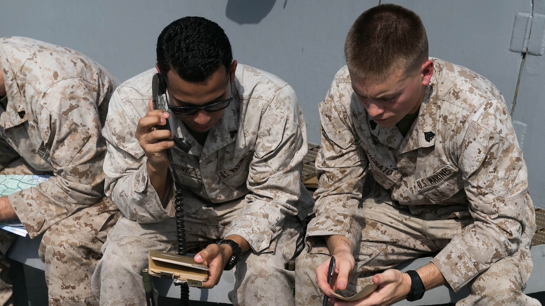 Sgt. Sean Vignato (right), a section chief, passes grid coordinates to Cpl. Christopher Nunez (left), a cannoneer, who relays them to the fire direction control center for a notional fire mission, during mission processing training aboard the amphibious transport dock ship USS Arlington, in the Gulf of Aden, Dec. 8, 2015. The Marines are with the 120mm Mortar Platoon, Battalion Landing Team 2/6, 26th Marine Expeditionary Unit, embarked aboard the USS Arlington. The 26th MEU is deployed to maintain regional security in the U.S. 5th Fleet area of operations. 