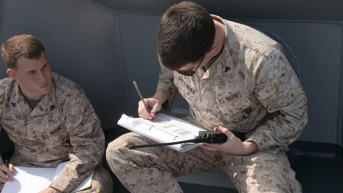 Cpl. Ryan Gilligan, a fire direction control man, with the 120mm Mortar Platoon, Battalion Landing Team 2/6, 26th Marine Expeditionary Unit, embarked aboard the amphibious transport dock ship USS Arlington (LPD 24), records information passed to him from the forward observers for a notional fire mission, during mission processing training in the Gulf of Aden, Dec. 8, 2015. The platoon conducts training while afloat in order to maintain readiness to support the 26th MEU. The MEU is deployed to maintain regional security in the U.S. 5th Fleet area of operations. 