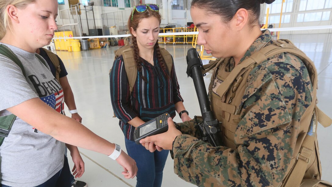 Cpl. Candice Lopez, a U.S. Marine with the 13th Marine Expeditionary Unit, scans the identification bands of evacuees, preparing them to be flown to a safe haven during a simulated noncombatant evacuation as part of Certification Exercise, Dec. 8, 2015. Noncombatant evacuations are one of the MEU's mission essential tasks, which it is specially trained to complete anywhere in the world within hours of notification. CERTEX is the final evaluation of the 13th Marine Expeditionary Unit and Boxer ARG prior to deployment and is intended to certify their readiness to conduct integrated missions across the full spectrum of military operations. 