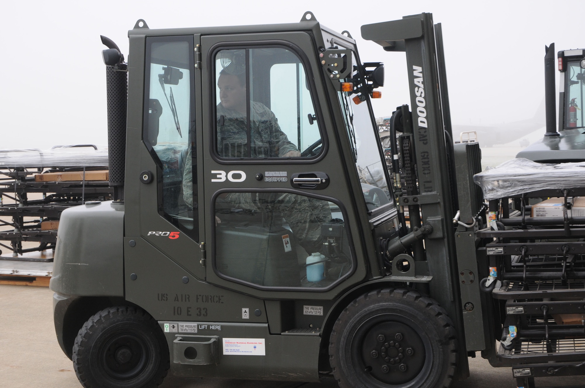 Tech. Sgt. Anthony Cresanto, an air transportation specialist assigned to the 76th Aerial Port Squadron, operates a forklift during a Denton Mission pallet build-up here, Dec. 5, 2015. The Denton program permits the Department of Defense to provide transportation of privately donated humanitarian assistance cargo to foreign countries using military transportation on a space-available basis. The cargo Cresanto is working on is bound for Honduras.  (U. S. Air Force photo/ Tech. Sgt. Rick Lisum)