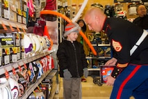 Staff Sgt. Benjamin Dittenbir, Recruiting Station Lansing, Recruiting Sub-Station Central Michigan staff noncommissioned officer-in-charge, helps Timothy Laskowski pick out a toy at Meijer’s Shop with the Heroes event in Mt. Pleasant, Mich., Dec. 8, 2015. Meijer selected a group of underprivileged kids and granted them a 100 dollar spending allowance so they could get their family members gifts, and maybe something for themselves too. They also had volunteers to help them wrap the gifts, provided pizza, drinks and a DJ for the kids and their families to enjoy.