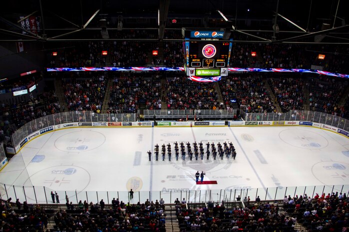 Marine Corps Poolees from Recruiting Sub-Station Grand Rapids South conduct a swear-in ceremony, led by Capt. Tracey Smith, Recruiting Station Lansing, Mich., executive officer, on the ice inside Van Andel Arena during the Grand Rapids Griffins hockey game, Dec. 9, 2015. According to Master Sgt. Kenneth Murillo, RS Lansing, RSS Grand Rapids South staff noncommissioned officer-in-charge, events like this are key in showing the Poolees they have their community’s support in their decision to join the United States Marine Corps and it helps keep them motivated. 