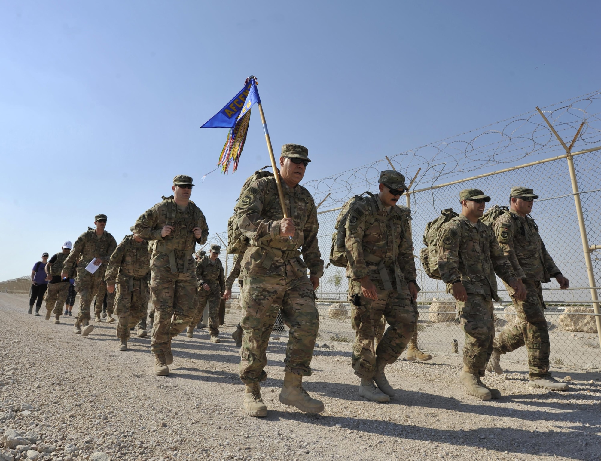 Members participate in the Fallen Defenders Ruck to Remember on Dec. 12, 2015, at Al Udeid Air Base, Qatar. The 12-kilometer ruck march honors security forces defenders who have made the ultimate sacrifice in support of operations in Iraq and Afghanistan. (U.S. Air Force photo/Master Sgt. Joshua Strang)