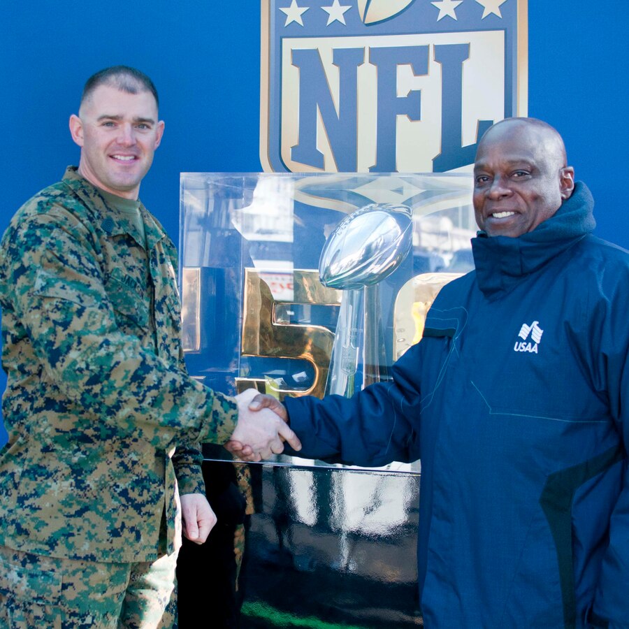 Master Sgt. Dan Jackson, Marine Corps Community Service senior enlisted advisor, meets Carl Bratton, USAA military affairs representative, during the Salute the Service Tour aboard Marine Corps Base Quantico hosted by USSA, the Military Sponsor of the NFL. Servicemembers  and their families had the unique opportunity to see this year’s Vince Lombardi Trophy. 