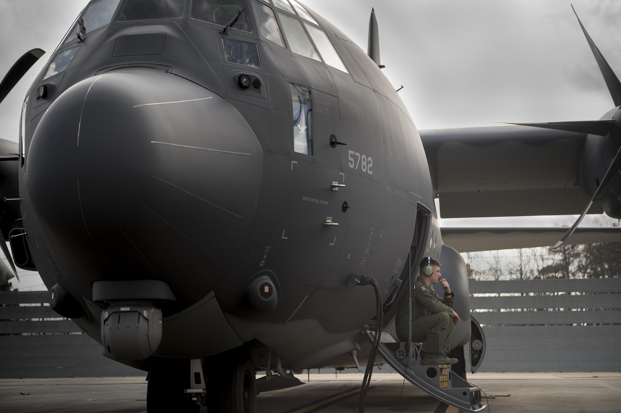 Senior Airman Kevin O’Neil, a 71st Rescue Squadron loadmaster, waits for engine startup Dec. 11, 2015, at a Lockheed Martin Corp. C-130 ramp in Marietta, Ga. The HC-130J Combat King II is the 2,500th C-130 manufactured by Lockheed Martin and is the seventh HC-130J the 71st RQS has received. (U.S. Air Force photo/Senior Airman Ryan Callaghan)