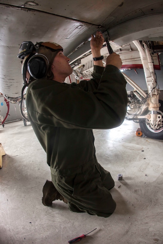 Marine Corps Lance Cpl. Austin L. Schetrompf tightens a wire on an EA-6B Prowler on Marine Corps Air Station Cherry Point, N.C., Dec. 1, 2015. Schetrompf is a power plant mechanic assigned to Marine Tactical Electronic Warfare Squadron 2. U.S. Marine Corps photo by Lance Cpl. Jered T. Stone