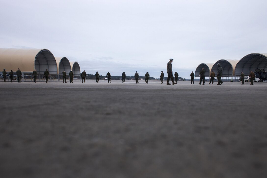 Marines participate in a foreign object debris walk on Marine Corps Air Station Cherry Point, N.C., Dec. 1, 2015. U.S. Marine Corps photo by Lance Cpl. Jered T. Stone