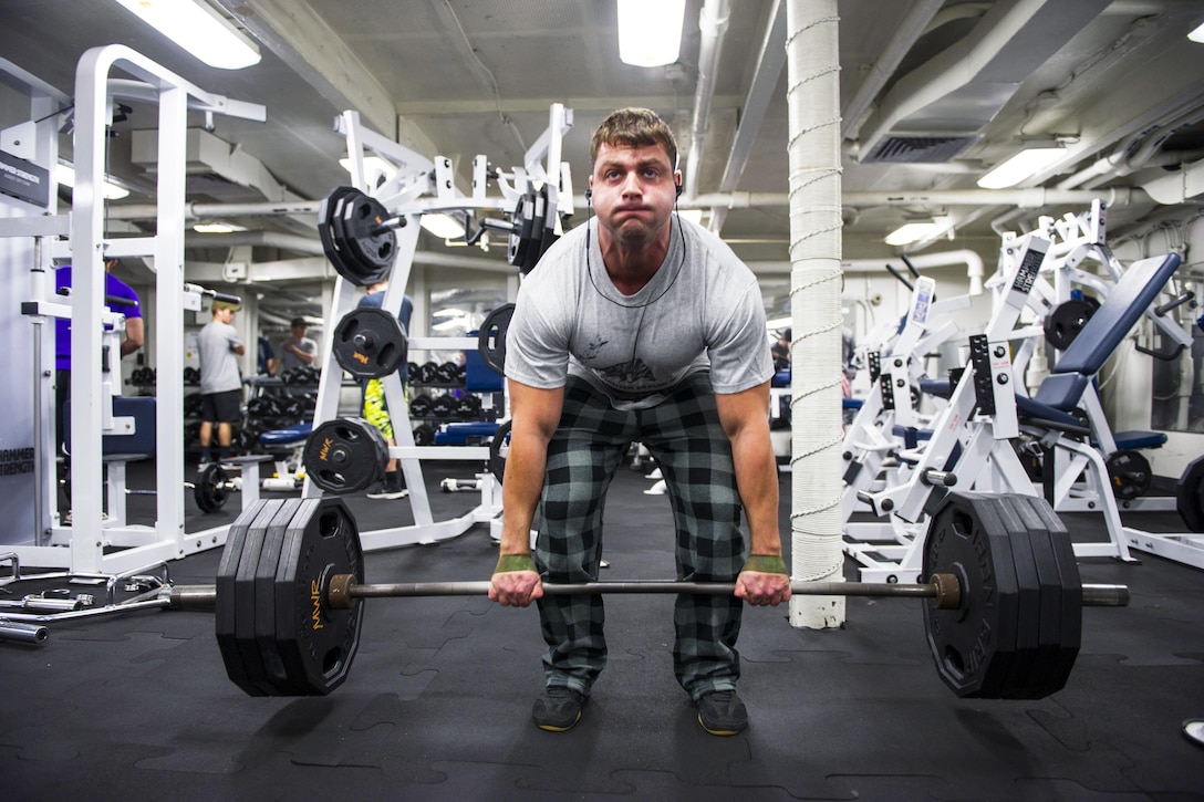 U.S. Navy Petty Officer 1st Class Charles Doyle exercises in the weight room aboard the aircraft carrier USS Dwight D. Eisenhower in the Atlantic Ocean, Dec. 12, 2015. The Eisenhower and embarked Carrier Air Wing 3 are preparing for their upcoming deployment. U.S. Navy photo by Petty Officer 3rd Class Taylor L. Jackson