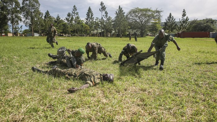 Uganda People’s Defense Force soldiers run to a notional injured soldier during a tactical combat casualty care exercise at Camp Singo, Uganda, Nov. 30, 2015. The UPDF medics and U.S. Navy corpsmen with Special-Purpose Marine Air-Ground Task Force Crisis Response-Africa, are training together to improve tactical medical care skills while strengthening the bond between the partner nations. 