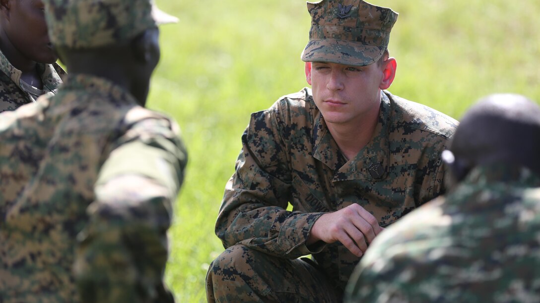 Petty Officer 3rd Class Paxton Dowd, corpsman with Special-Purpose Marine Air-Ground Task Force Crisis Response-Africa, listens to a Uganda People’s Defense Force medic explain his course of treatment during a tactical combat casualty care exercise at Camp Singo, Uganda, Nov. 30, 2015. The UPDF medics and corpsmen are training together to improve tactical medical care skills while strengthening the bond between the partner nations. 
