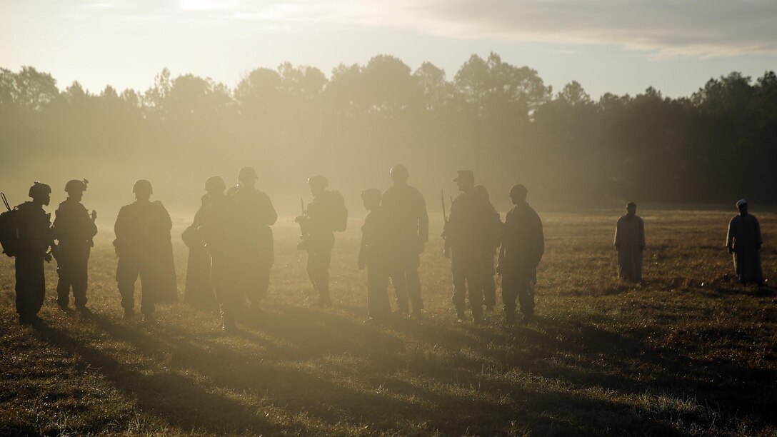 Marines with 2nd Air Naval Gunfire Liaison Company, II Marine Headquarters Group, secure an area with coalition force role players at Marine Corps Base Camp Lejeune, N.C., during a Security Assistance Liaison Team training exercise to improve their ability to work with coalition forces, Dec. 10, 2015. The Security Assistance Liaison Team will support Operation Resolute Support in Afghanistan under the authority of United Nations Security Council Resolution 2189.  
