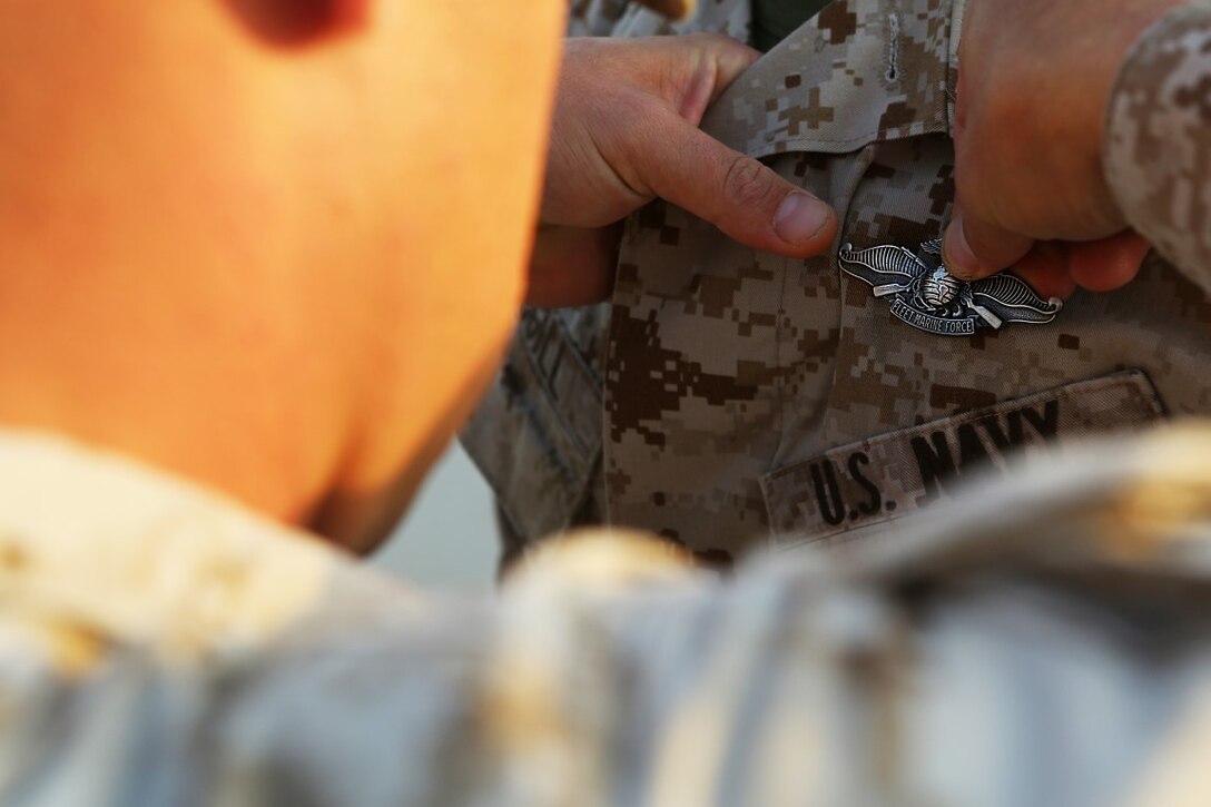 U.S. Navy Petty Officer 2nd Class Ambrose McGill, a hospital corpsman with Special Purpose Marine Air Ground Task Force—Crisis Response—Central Command, was awarded the Fleet Marine Force pin during a recognition ceremony at an undisclosed location in Southwest Asia, Dec. 12, 2015. McGill spent countless hours reviewing the vast amount of material required to earn the pin. McGill said, he wanted to earn this since the first day he became a hospital corpsman. (Marine Corps photo by Sgt. Owen Kimbrel/RELEASED)