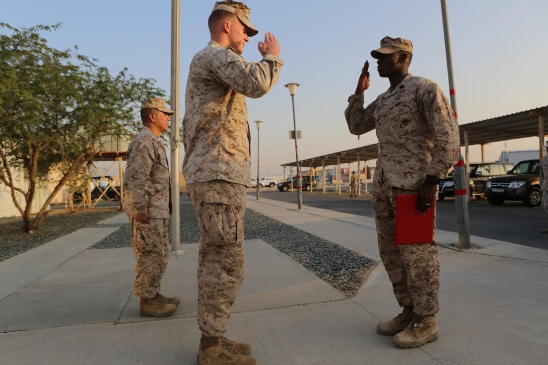 U.S. Navy Petty Officer 2nd Class Ambrose McGill, right, a hospital corpsman with Special Purpose Marine Air Ground Task Force—Crisis Response—Central Command, salutes U.S. Marine 1st Lt. Timothy Denning, the Headquarters Company commander with SPMAGTF CR-CC, after receiving his Fleet Marine Force pin during a recognition ceremony at an undisclosed location in Southwest Asia, Dec. 12, 2015. The FMF pin is earned through a multitude of tests ranging from academic exams to practical applications on various weapon systems. (U.S. Marine Corps photo by Sgt. Owen Kimbrel/RELEASED)