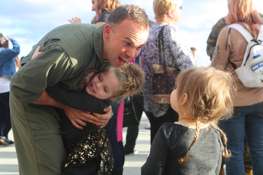 A Marine greets loved ones upon arriving on Marine Corps Air Station Miramar, Calif., Dec. 13, 2015. Marine with Marine Medium Tiltrotor Squadron 161 returned following a seven-month deployment as the aviation combat element of the 15th Marine Expeditionary Unit. U.S. Marine Corps photo by Lance Cpl. Harley Robinson