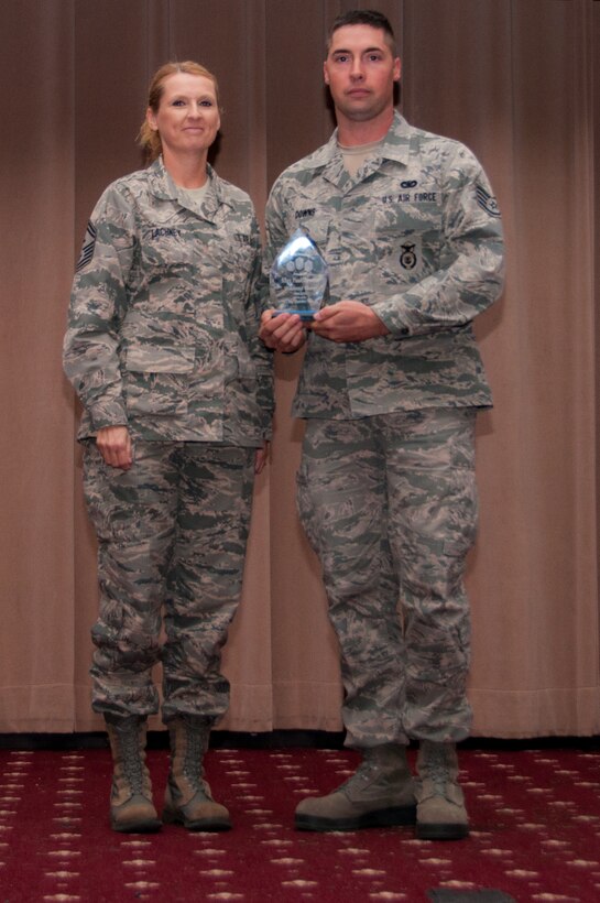 U.S. Air Force Senior Master Sgt. Kay Lachney presents Staff Sgt. Paul Downs with the First Sergeants Council’s Diamond Sharp Award for the period covering July to September 2015 during the 307th Bomb Wing Commander’s Call on Dec. 6, 2015, Barksdale Air Force Base, La.  Downs is assigned to the 307th Security Forces Squadron. (U.S. Air Force photo by Master Sgt. Laura Siebert/Released)