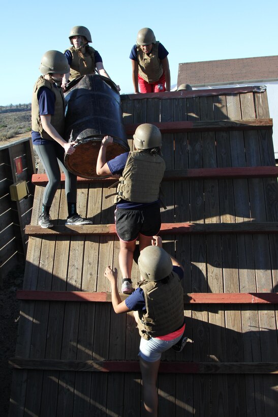Marine enlistees conduct an obstacle, requiring teamwork and strategic planning during a pool function at Weapons Field Training Battalion, Marine Corps Base Camp Pendleton, Calif., Dec. 12, 2015. During the event, recruiters teamed with drill instructors to mentally and physically prepare enlistees from Los Angeles, San Diego and Orange County for boot camp and taught classes about military appearance and Marine Corps history. (U.S. Marine Corps photo by Staff Sgt. Alicia R. Leaders/Released)