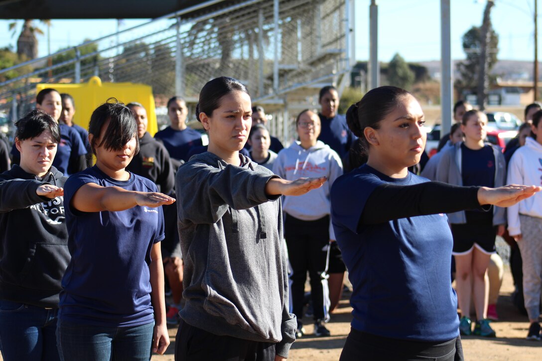 Marine enlistees learn the basics of drill from Marine Corps drill instructors during a combined pool function from Recruiting Stations Los Angeles, San Diego and Orange County at Weapons Field Training Battalion, Marine Corps Base Camp Pendleton, Calif., Dec. 12, 2015. During the event, recruiters teamed with drill instructors to mentally and physically prepare enlistees from Los Angeles, San Diego and Orange County for boot camp and taught classes about military appearance and Marine Corps history. (U.S. Marine Corps photo by Staff Sgt. Alicia R. Leaders/Released)