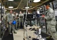 Senior Airman Jason Yumen, a radio frequency technician for the 169th Air Defense Squadron, briefs 15th Wing and Hawaii Air National Guard leaders on the mission of the 169th ADS during a tour of the Mount Kaala Air Force Station, Hawaii, Dec. 4, 2015. With an elevation of roughly 4,000 feet, Mount Kaala Air Force Station is the heist point on the island of Oahu. (U.S. Air Force photo by Tech. Sgt. Aaron Oelrich/Released)