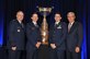 Air Force Chief of Staff Gen. Mark A. Welsh III accompanied by a National Aeronautic Association spokesman present the Mackay Trophy to Capts. David Kroontje and Gregory Balzhiser during the NAA fall awards ceremony in Arlington, Va., Dec. 3, 2015. Kroontje and Balzhiser earned the trophy as a result of their heroic efforts during an airstrike that helped Kurdish Peshmerga forces the next day set up a safe corridor from Mount Sinjar, Iraq, saving the lives of 40,000 stranded civilians including women, children, elderly, and the infirm. (Courtesy photo)