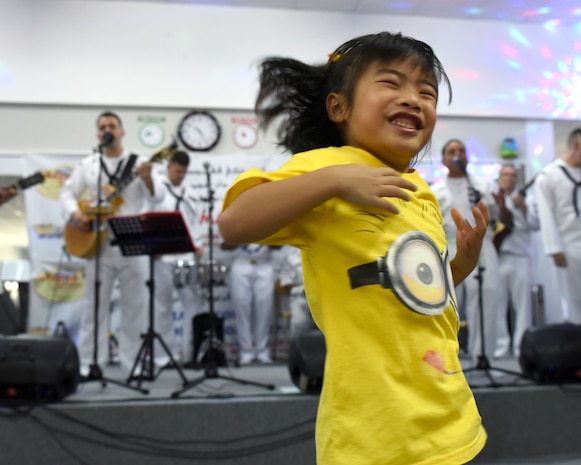 A student from SMARTER Brunei, a center dedicated to helping people of all ages with autism, dances during a performance featuring both the U.S. 7th Fleet Band's contemporary music ensemble Orient Express and the Royal Brunei Navy Band during Cooperation Afloat Readiness and Training (CARAT) Brunei 2015. CARAT is a series of annual, bilateral maritime exercises between the U.S. Navy, U.S. Marine Corps, and the armed forces of nine partner nations to include Bangladesh, Brunei, Cambodia, Indonesia, Malaysia, the Philippines, Singapore, Thailand, and Timor-Leste. (U.S. Navy photo by Mass Communication Specialist 2nd Class Jacob I. Allison/Released)              