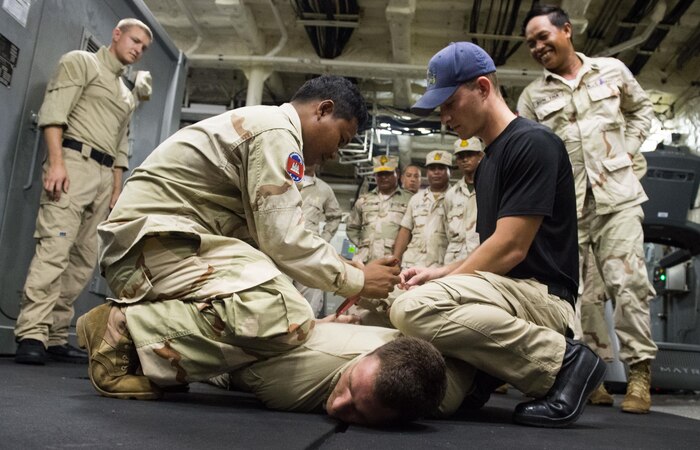 Members of Littoral Combat Ship Surface Warfare Detachment 6 (SUW Det 6) share visit, board, search, and seizer tactics with members of the Royal Cambodian Navy aboard USS Fort Worth (LCS 3) during Cooperation Afloat Readiness and Training (CARAT) Cambodia 2015. CARAT is a series of annual, bilateral maritime exercises between the U.S. Navy, U.S. Marine Corps and the armed forces of nine partner nations to include Bangladesh, Brunei, Cambodia, Indonesia, Malaysia, the Philippines, Singapore, Thailand, and Timor-Leste. (U.S. Navy photo by Mass Communication Specialist 2nd Class Antonio Turretto Ramos/Released)         