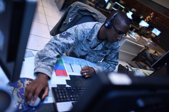 U.S. Air Force Tech. Sgt. Robert Williams, 176th Air Defense Squadron weapons director, prepares to help Alaskan NORAD Region track Santa this Christmas Eve. For 60 years the North American Aerospace Defense Command, including ANR at Joint Base Elmendorf-Richardson, has tracked Santa’s movements as he travels around the globe on Christmas. The dedicated men and women of ANR have made the vital preparations necessary to help keep Santa safe on his journey around the world. When not tracking Santa, ANR's mission is to continuously provide warning of a possible aerospace attack within the region and will maintain aerospace control to include peacetime air sovereignty and appropriate aerospace defense measures in response to hostile actions within ANR's area of operation 24 hours a day, 365 days a year. (U.S. Air Force photo by Tech. Sgt. John Gordinier/Released)