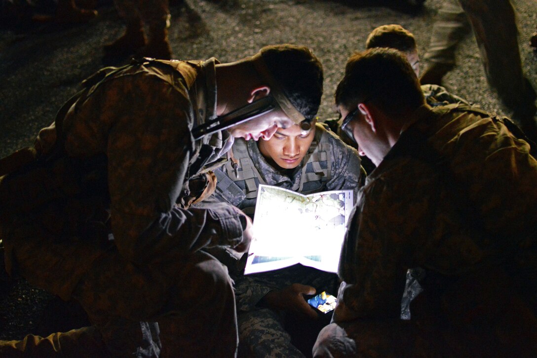 Soldiers look over a map of a landing site on Wheeler Army Airfield, Hawaii, Dec. 2, 2015. The soldiers flew aboard UH-60 Black Hawk helicopters to conduct air assault operations training on Marine Corps Training Area Bellows. U.S. Army photo by Staff Sgt. Armando Limon