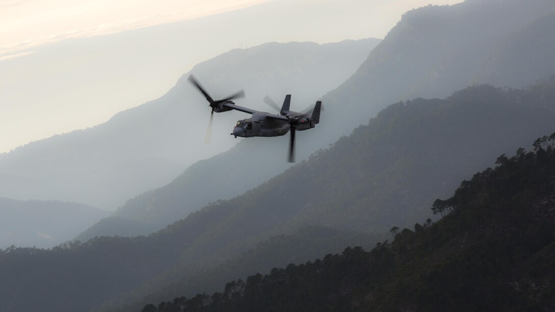 An MV-22B Osprey with Special-Purpose Marine Air-Ground Task Force Crisis Response-Africa carves through mountain terrain during a tactical recovery of aircraft and personnel exercise, Dec. 7, 2015 near Albacete, Spain. The TRAP is part of a month-long training curriculum hosted by the Tactical Leadership Programme, a 10 NATO nation collaboration, who train future flight commanders. 