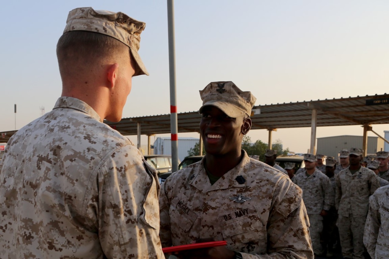 U.S. Navy Petty Officer 2nd Class Ambrose McGill, a hospital corpsman with Special Purpose Marine Air Ground Task Force—Crisis Response—Central Command, is presented his Fleet Marine Force pin during a recognition ceremony at an undisclosed location in Southwest Asia, Dec. 12, 2015. McGill spent countless hours studying Marine Corps knowledge that Marines would receive during boot camp in order to earn the pin. (U.S. Marine Corps photo by Sgt. Owen Kimbrel/RELEASED)