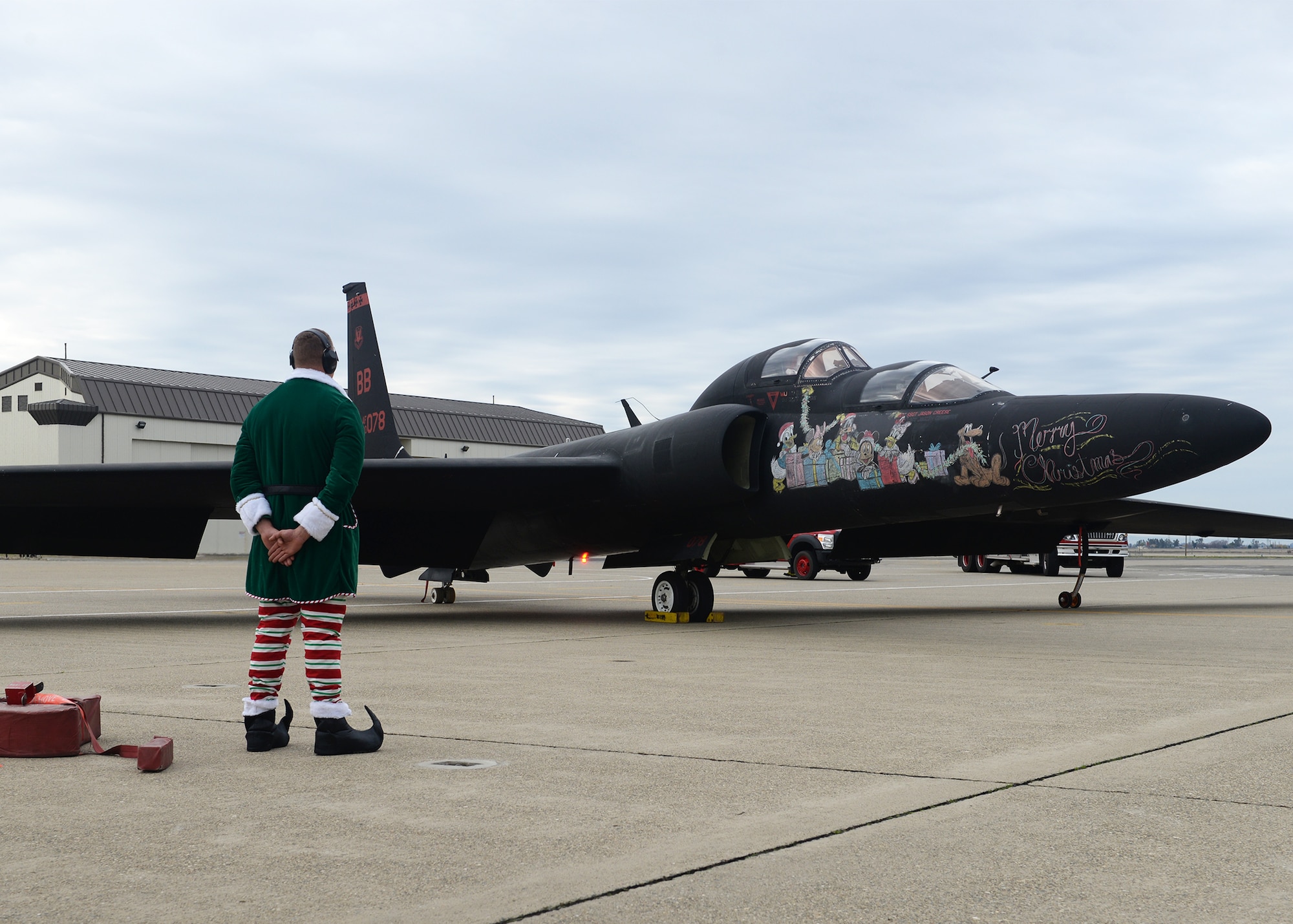 Santa Clause arrives in a U-2 Dragon Lady and his elf waits for him to exit the aircraft during the annual Children's Holiday Party Dec. 12, 2015, at Beale Air Force Base, California. Thousands of presents were donated by multiple suppliers and were handed out to the children of Team Beale. In addition, the event included photos with Santa Clause and his elves, a raffle and various holiday activities. (U.S. Air Force photo by Airman 1st Class Ramon A. Adelan)