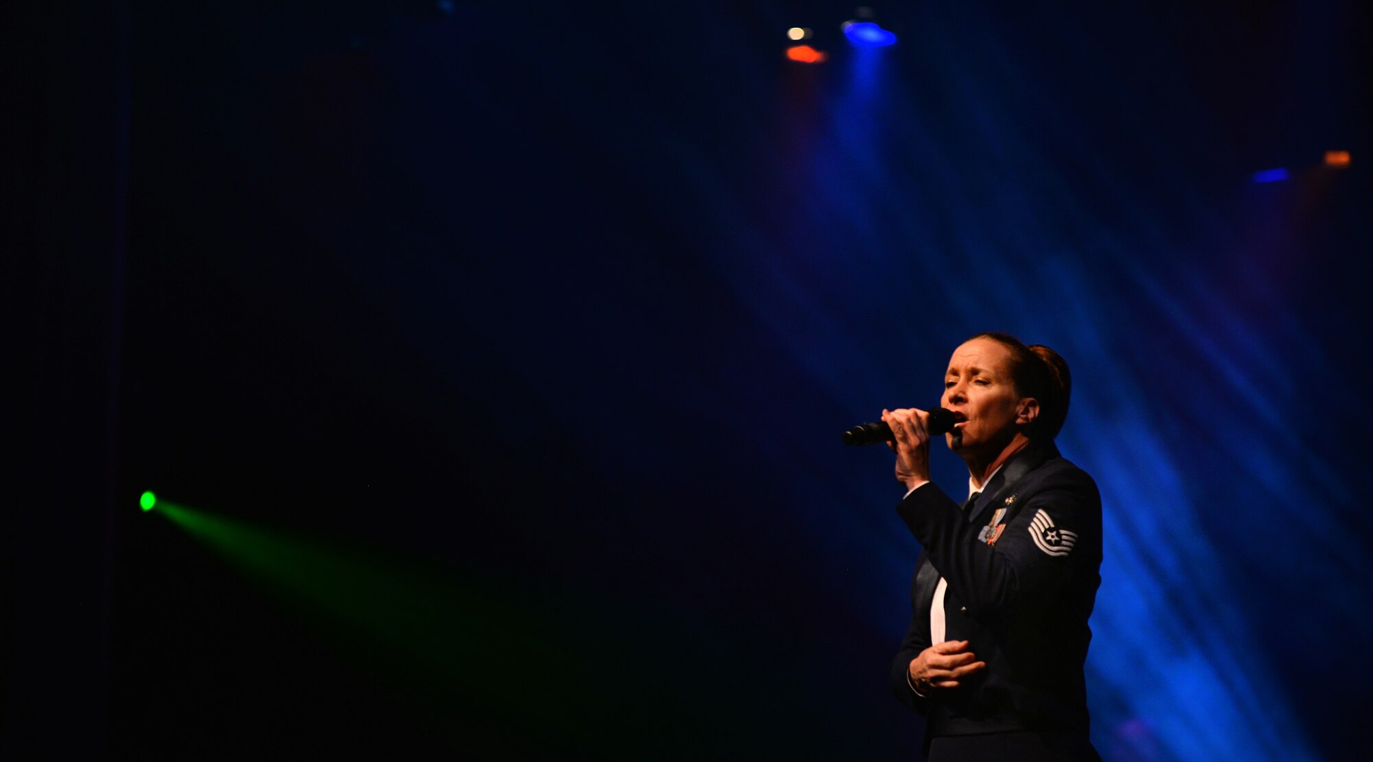 U.S. Air Force Tech. Sgt. Rebecca Packard, vocalist with the United States Air Force Heartland of America Band, performs at the “Sounds of the Season” holiday concert series held at Bellevue East High School on Dec. 12 in Bellevue, Neb.  Bellevue East has long been a supporter of the holiday concert series, providing Reserve Officer Training Corps volunteers for the annual event.  (U.S. Air Force photo by Josh Plueger)
