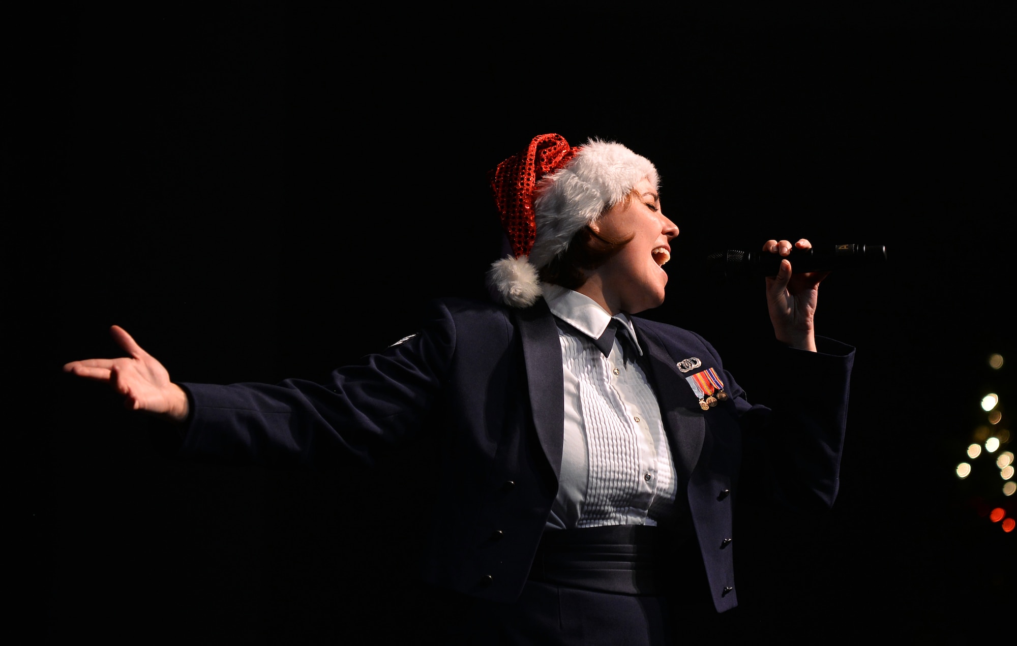 U.S. Air Force Senior Airman Alena Zidlicky, a vocalist and French Horn player with the United States Air Force Heartland of America Band, sings a solo at the 2015 “Sounds of the Season” holiday concert series held at Bellevue East High School on Dec. 12 in Bellevue, Neb.  The holiday concert series goes to several metro area schools over the two-week performance.  (U.S. Air Force photo by Josh Plueger)
