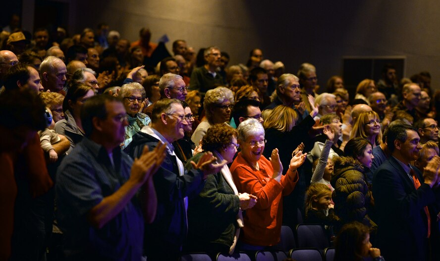 People offer a standing ovation at the conclusion of the “Sounds of the Season” concert performed by the United States Air Force Heartland of America Band at Bellevue East High School on Dec. 12. The band will perform holiday concerts for three weeks in December.  (U.S. Air Force photo by Josh Plueger)