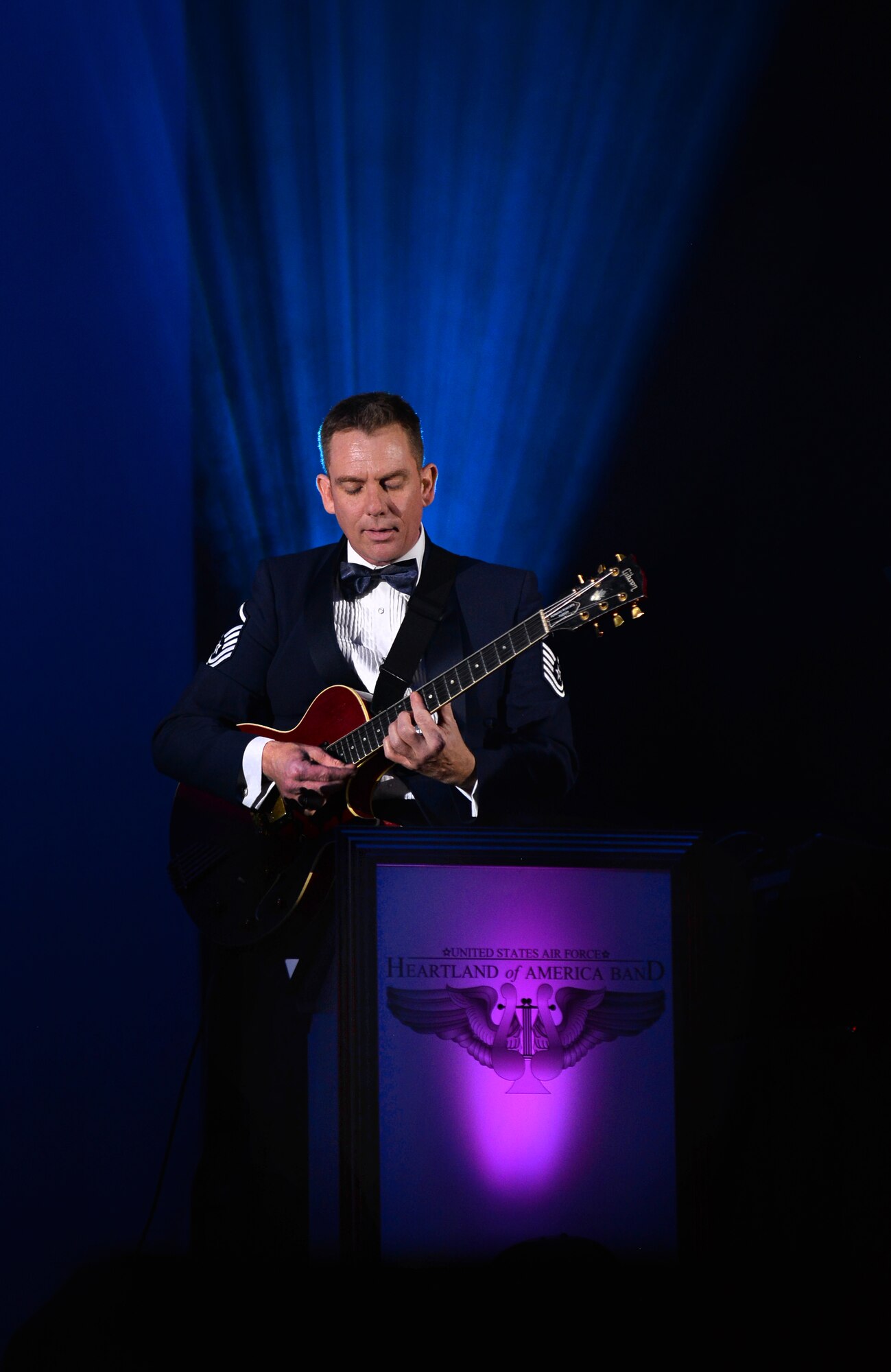 U.S. Air Force Master Sgt. Gerard Birkenmeier, a guitarist with the United States Air Force Heartland of America Band, performs at the “Sounds of the Season” holiday concert series inside of the Bellevue East High School’s auditorium on Dec. 12 in Bellevue, Neb.  The 15 member ensemble will perform at three area high schools throughout the holiday season.  (U.S. Air Force photo by Josh Plueger)