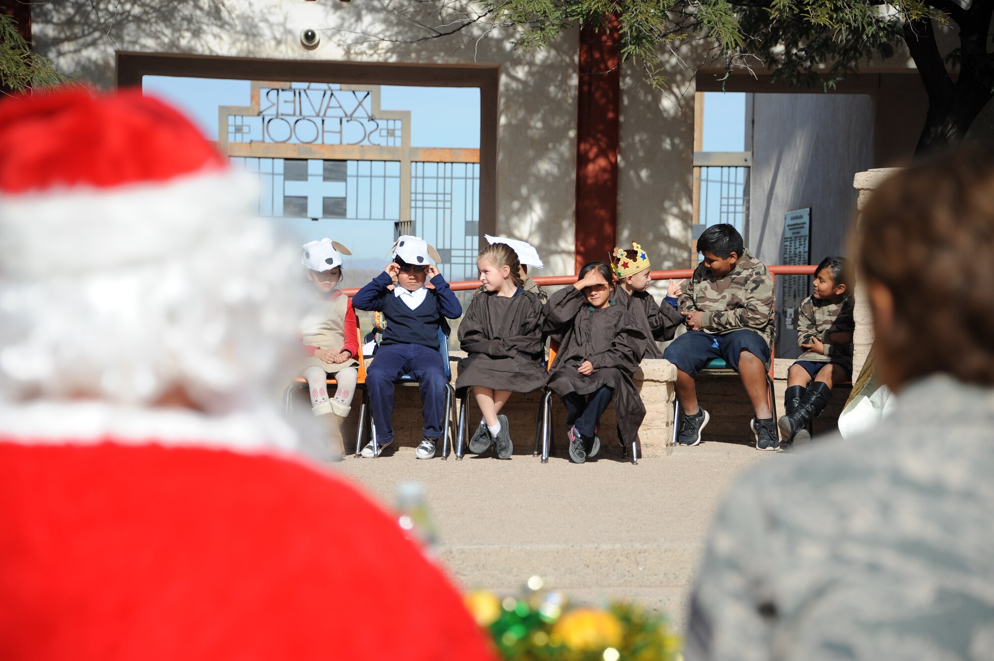 San Xavier Mission School students prepare to put on a play after Davis-Monthan Air Force Base’s 50th Anniversary Santas in Blue event at San Xavier Mission School in Tucson, Ariz., Dec. 10, 2015. The school hosted a play to thank the D-M AFB Airmen volunteers who helped with the event (U.S. Air Force photo by Airman 1st Class Ashley N. Steffen/Released)
