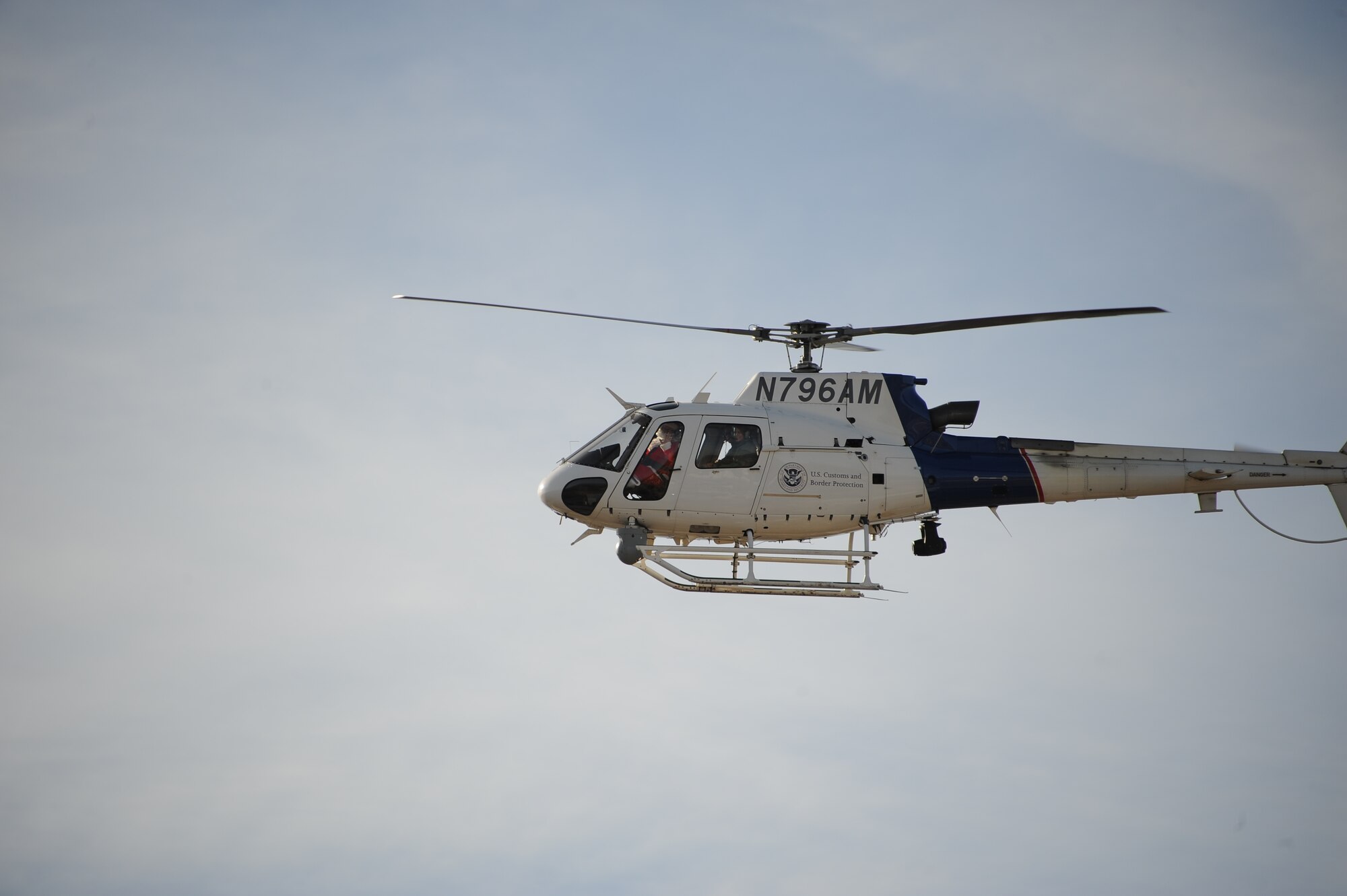 A U.S. Customs and Border Protection’s Office of Air and Marine AS-350 Light Enforcement Helicopter delivers Santa Claus, U.S. Air Force Col. James Meger, 355th Fighter Wing commander, Chief Master Sgt. Dawn Kolczynski, 355th Medical Group superintendent, to San Xavier Mission School for Davis-Monthan Air Force Base’s 50th Anniversary Santas in Blue event in Tucson, Ariz., Dec. 10, 2015. Santa waved to children and families while circling over the school. (U.S. Air Force photo by Airman 1st Class Ashley N. Steffen/Released)