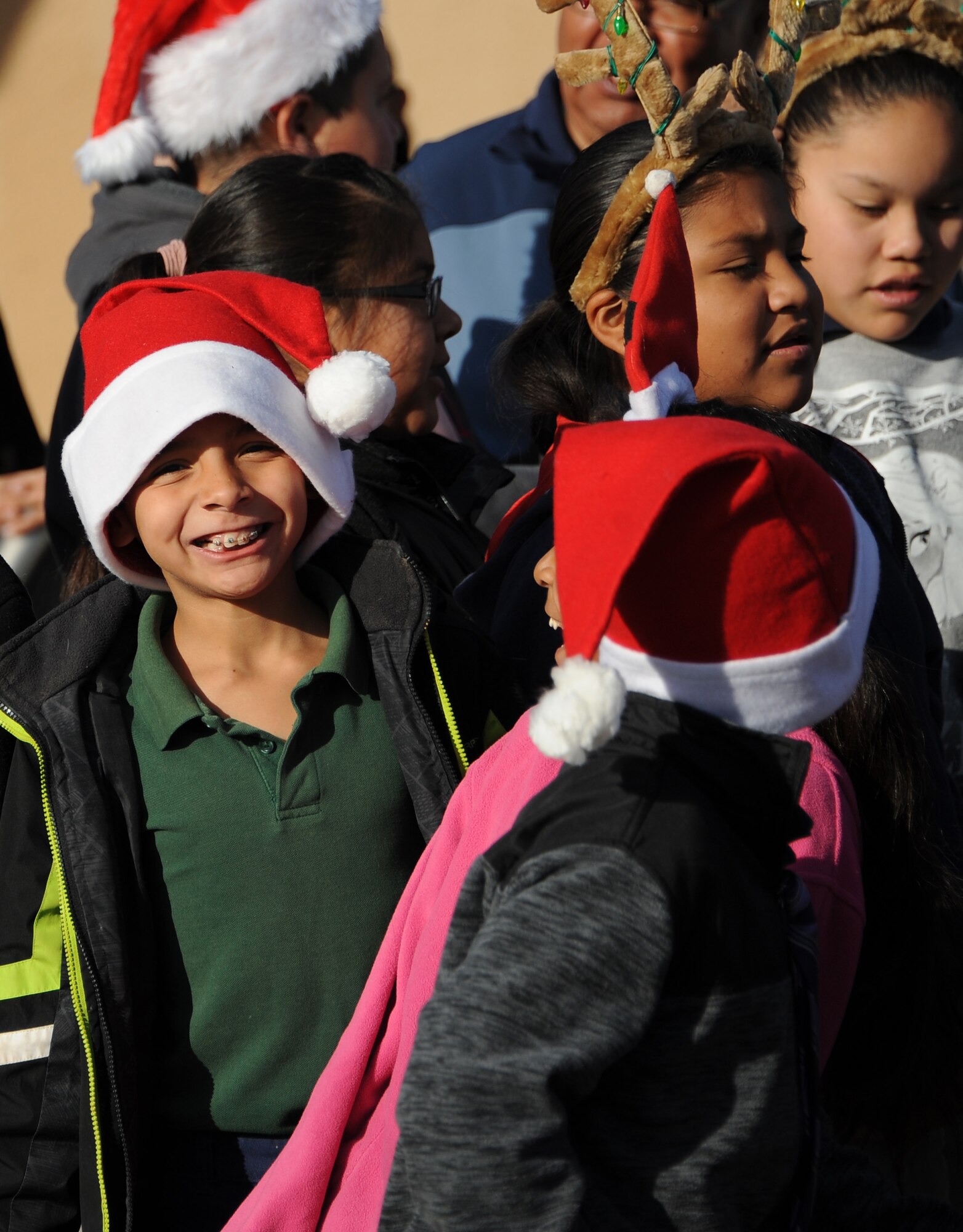 San Xavier Mission school students wait for Santa Claus to arrive during Davis-Monthan Air Force Base’s 50th Anniversary Santas in Blue event at San Xavier Mission School in Tucson, Ariz., Dec. 10, 2015. Santa Claus arrived by helicopter and landed in San Xavier Mission’s Plaza parking lot. (U.S. Air Force photo by Airman 1st Class Ashley N. Steffen/Released)