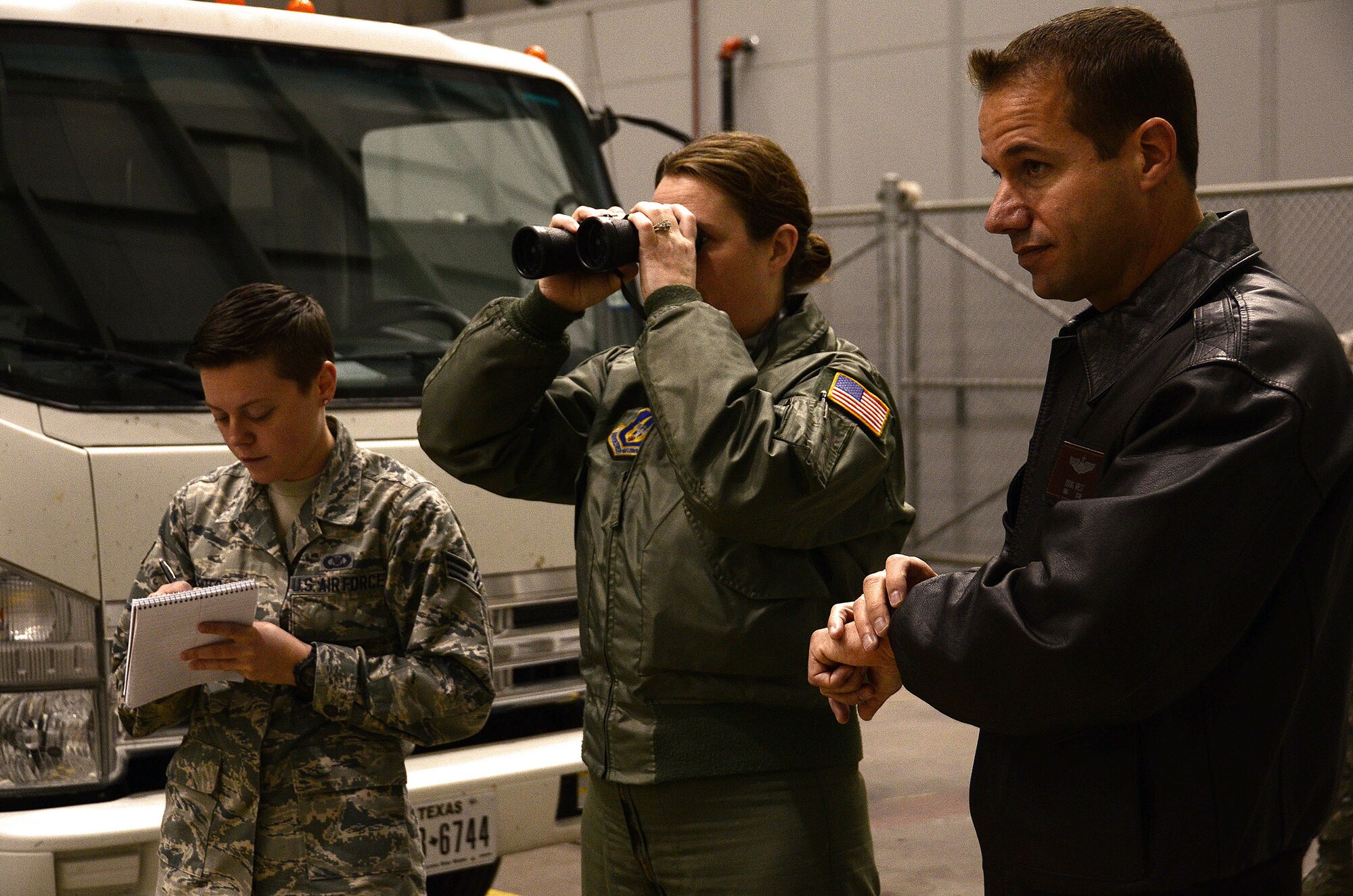 WRIGHT-PATTERSON AIR FORCE BASE, Ohio - During the Nov. 15, 2015 Warrior Challenge SALUTE event, Master Sgt. Caroline Sussman, 89th Airlift Squadron loadmaster, utilizes a set of binoculars to call out enemy forces as Senior Airman Ash Senter, 89th AS squadron aviation resource management helper, scribes the information that she is relaying to her in SALUTE format. (U.S. Air Force photo/Tech. Sgt. Patrick O'Reilly) 