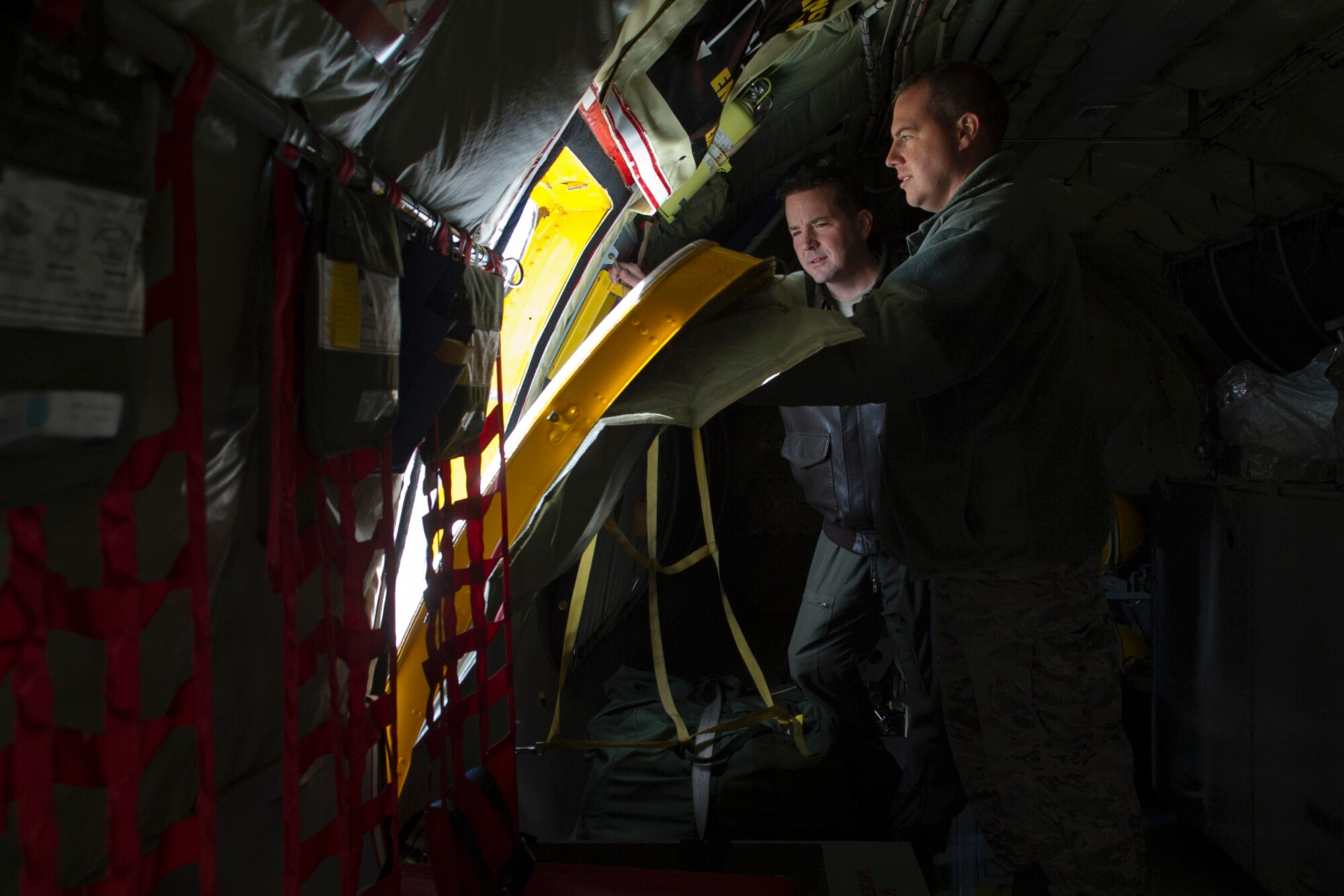 Maj. Jeffrey Benware, 434th Air Refueling Wing chief of safety (left), observes Master Sgt. Jason Washburn, 434th Aircraft Maintenance Squadron flightline expeditor, ensures a proper seal of a cargo door at Grissom Air Reserve Base, Ind., Nov. 19, 2015. Benware manages ground, weapons and flight safety, and conducts investigations to prevent mishaps and correct inadequacies. (U.S. Air Force photo/Senior Airman Katrina Heikkinen)