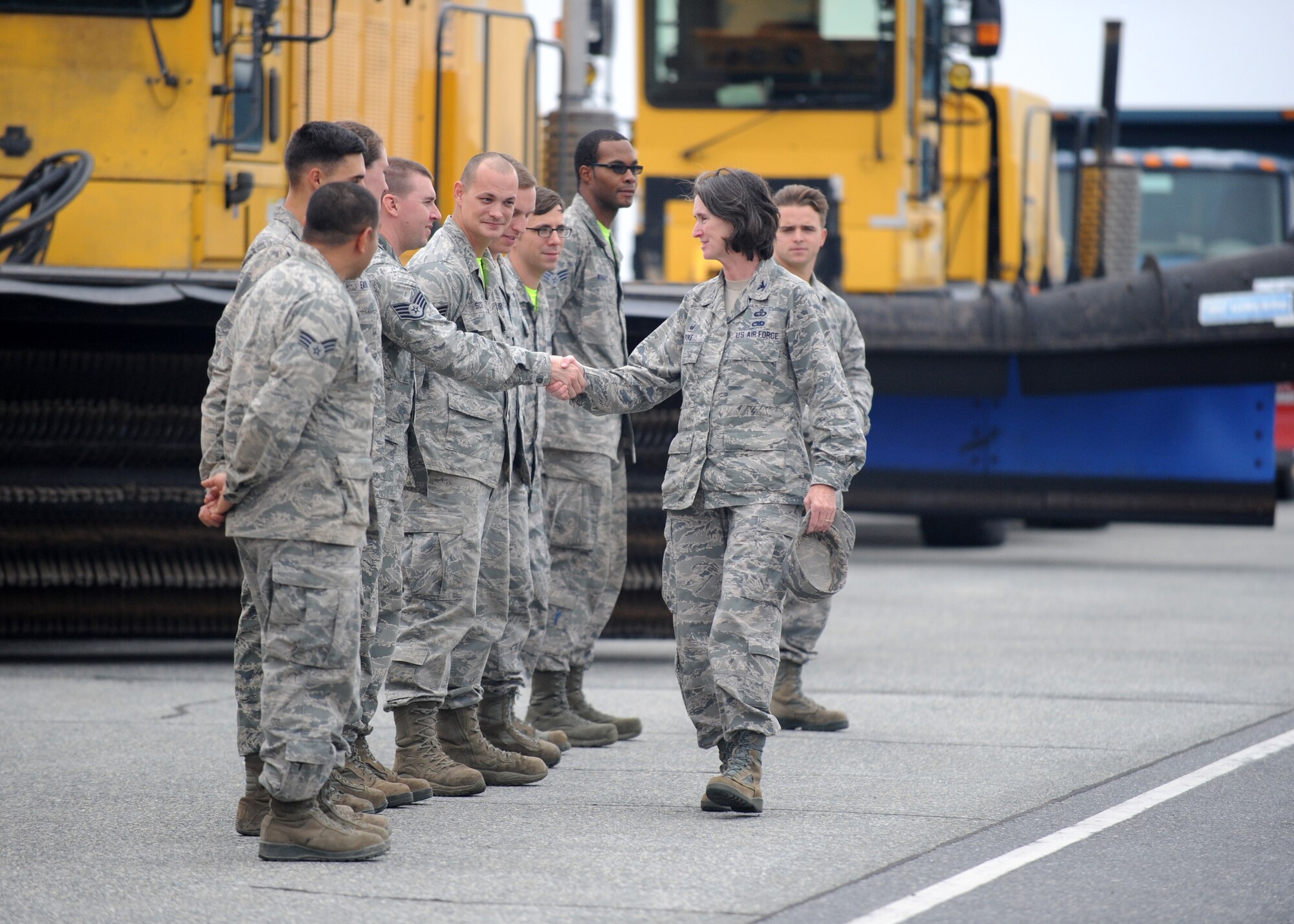 Col. Lisa Pike, 436th Mission Support Group commander, shakes hands of 436th Civil Engineer Squadron members after a snow parade demonstration Nov. 6, 2015, at Dover Air Force Base, Del. Commanders from around the base attended the annual briefing and demonstration to learn more about the snow removal process. (U.S. Air Force photo/Tech. Sgt. Elizabeth Morris)