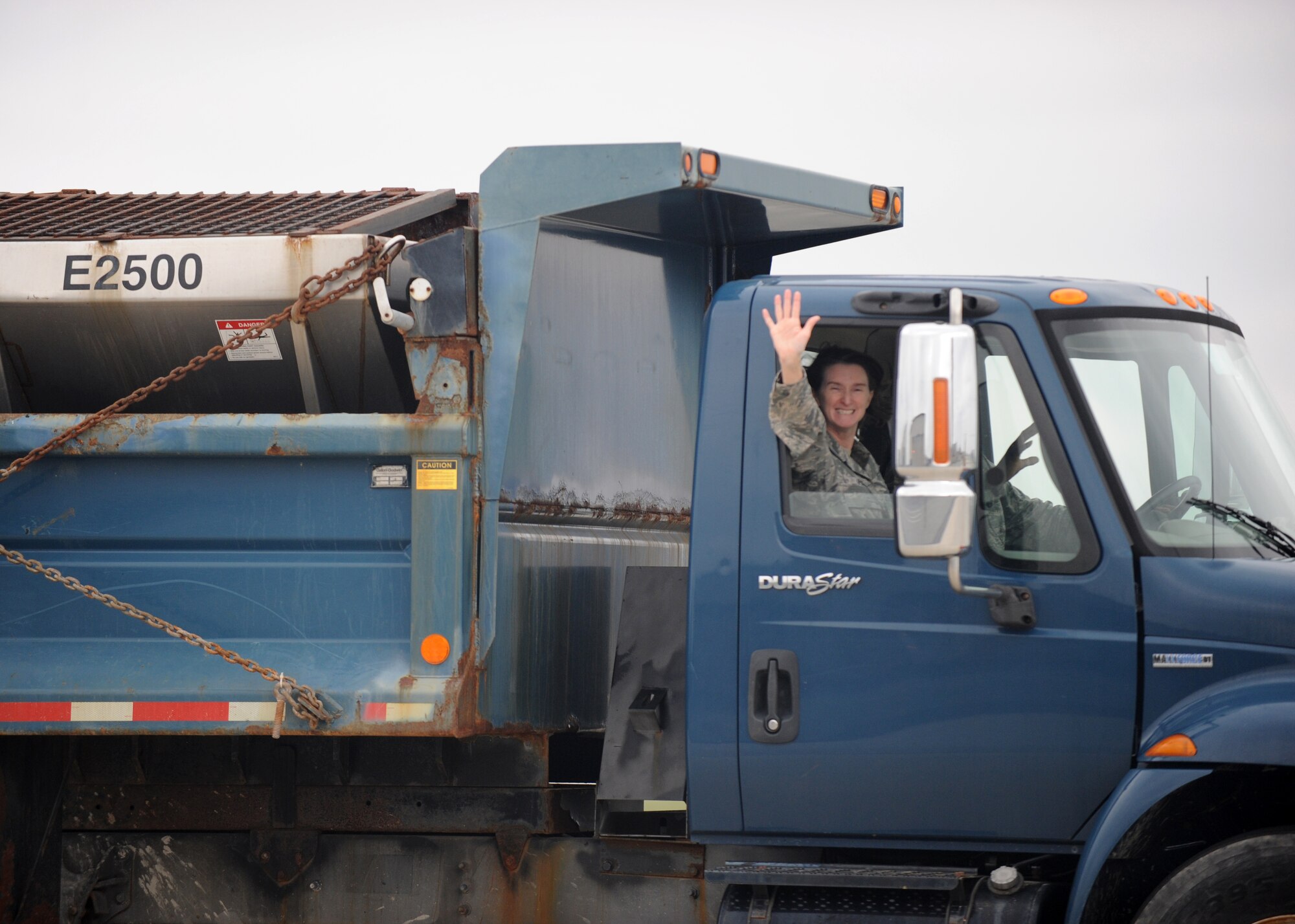 Col. Lisa Pike, 436th Mission Support Group commander, waves while taking a ride in a snow removal vehicle Nov. 6, 2015, at Dover Air Force Base, Del. Commanders from around the base attended an annual briefing and demonstration, known as the snow parade, to learn more about the snow removal process. (U.S. Air Force photo/Tech. Sgt. Elizabeth Morris)