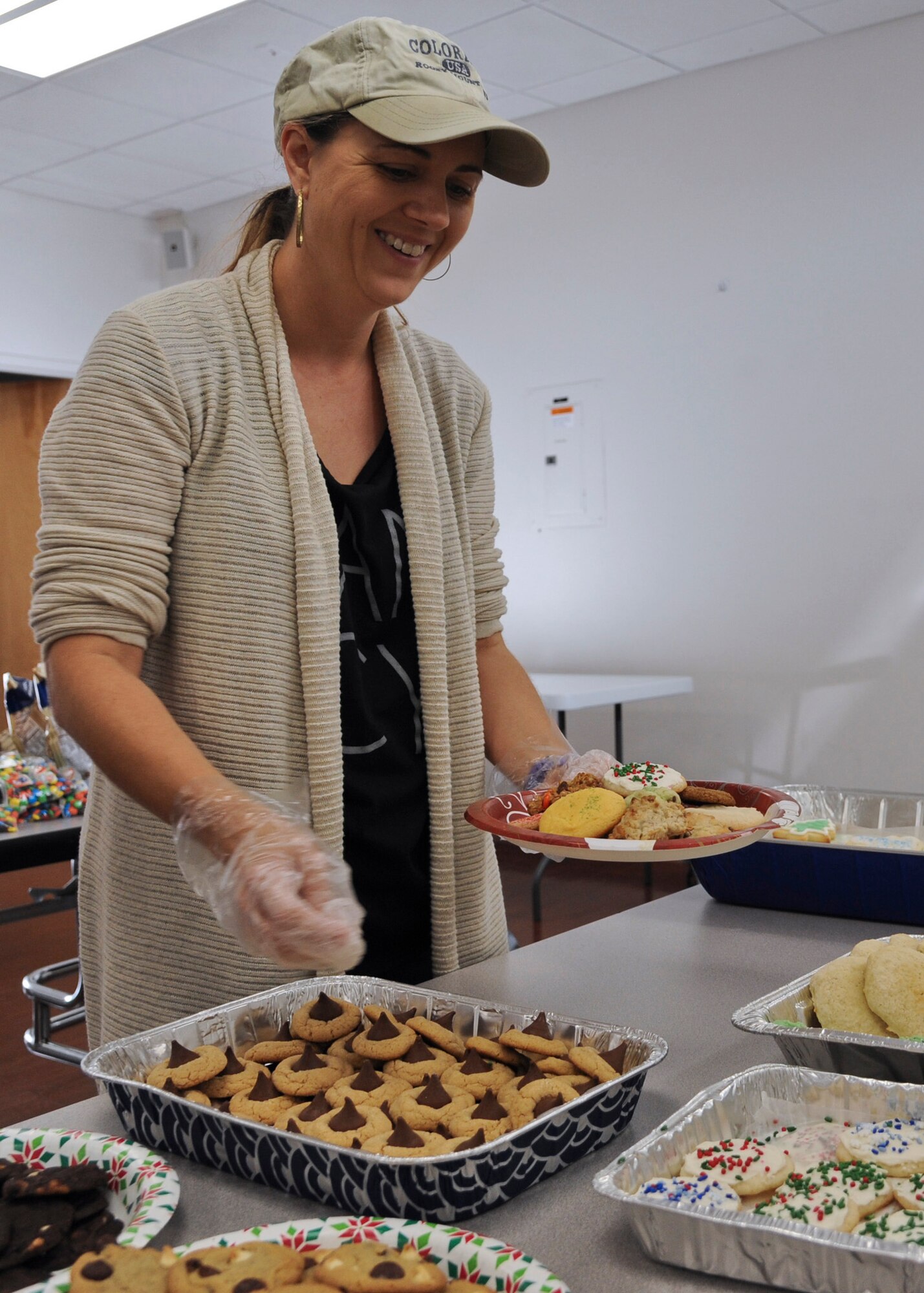 Angela Peske, member of the MacDill Officers’ Spouses’ Club, collects homemade cookies on a plate to be given to dorm residents at MacDill Air Force Base, Fla., Dec. 8, 2015. Approximately 4,560 cookies were donated by the MacDill community for Operation Cookie Drop 2015. (U.S. Air Force photo by Senior Airman Danielle Quilla)